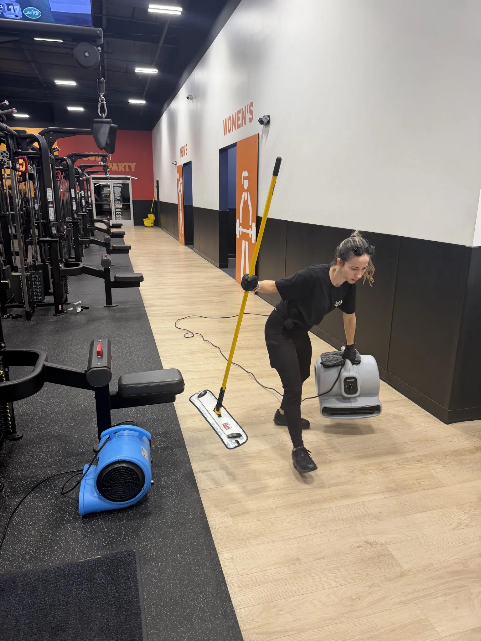 Commercial cleaner working on a gym floor